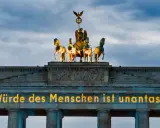 Brandenburger Tor mit leuchtender Botschaft "Die Würde des Menschen ist unantastbar." Ein Symbol für Freiheit und den Tag der Befreiung.