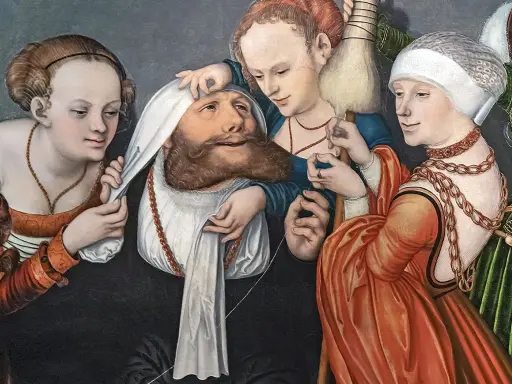 Lucas Cranach malt drei Frauen, die einen Mann mit Bart und weißem Tuch um den Kopf umgeben. Eine hält ein Spinnrad.