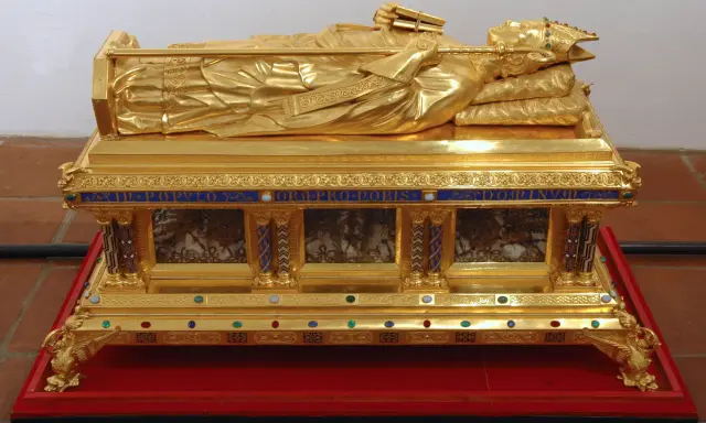 Vergoldete Reliquien-Truhe mit liegender Figur, die ein Buch und einen Stab hält. Ein kostbares Zeugnis der Reliquien Jesu.